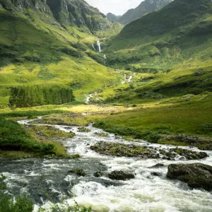 vertical-shot-river-surrounded-by-mountains-meadows-scotland (1)
